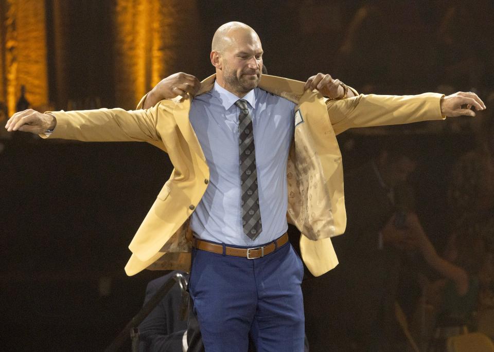 Joe Thomas is helped into his gold jacket by Hall of Famer Jerome Bettis at the 2023 Hall of Fame Enshrinees' Gold Jacket Dinner held at the Canton Civic Center. 