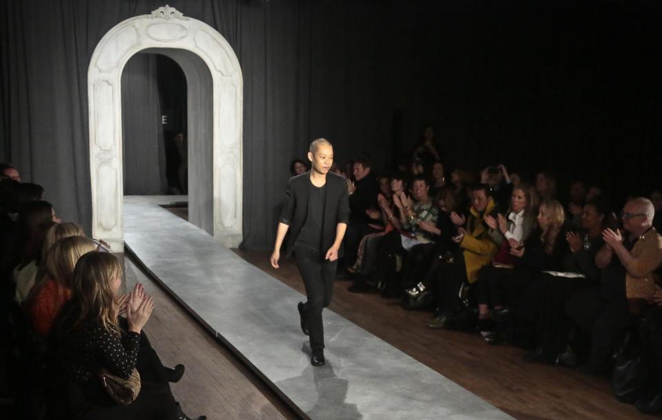 Jason Wu walks the runway after unveiling his Fall 2014 collection, during New York Fashion Week on Friday Feb. 7, 2014. (AP Photo/Bebeto Matthews)
