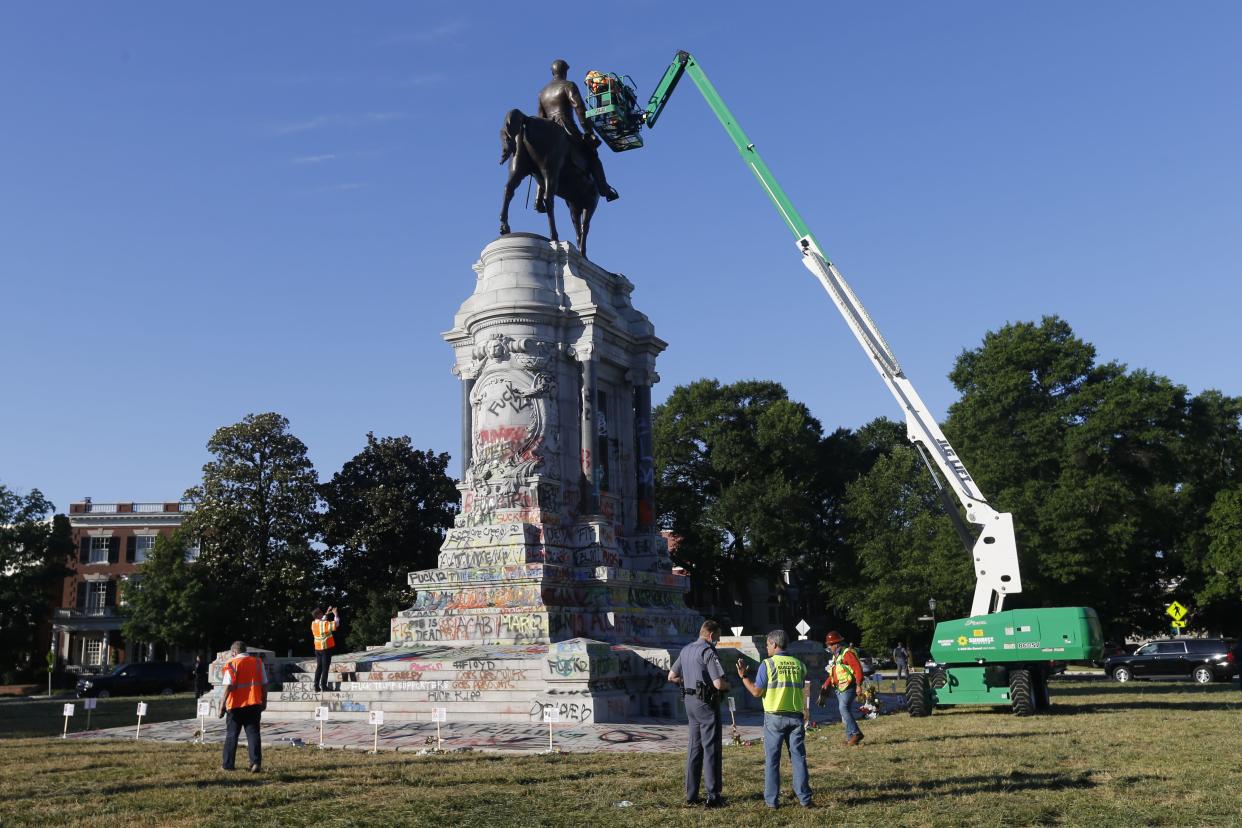 An inspection crew from the Virginia Department of General Services inspect the statue of Confederate Gen. Robert E. Lee on Monument Avenue on June. 8, 2020 in Richmond, Va. Virginia Gov. Ralph Northam has ordered the removal of the statue.