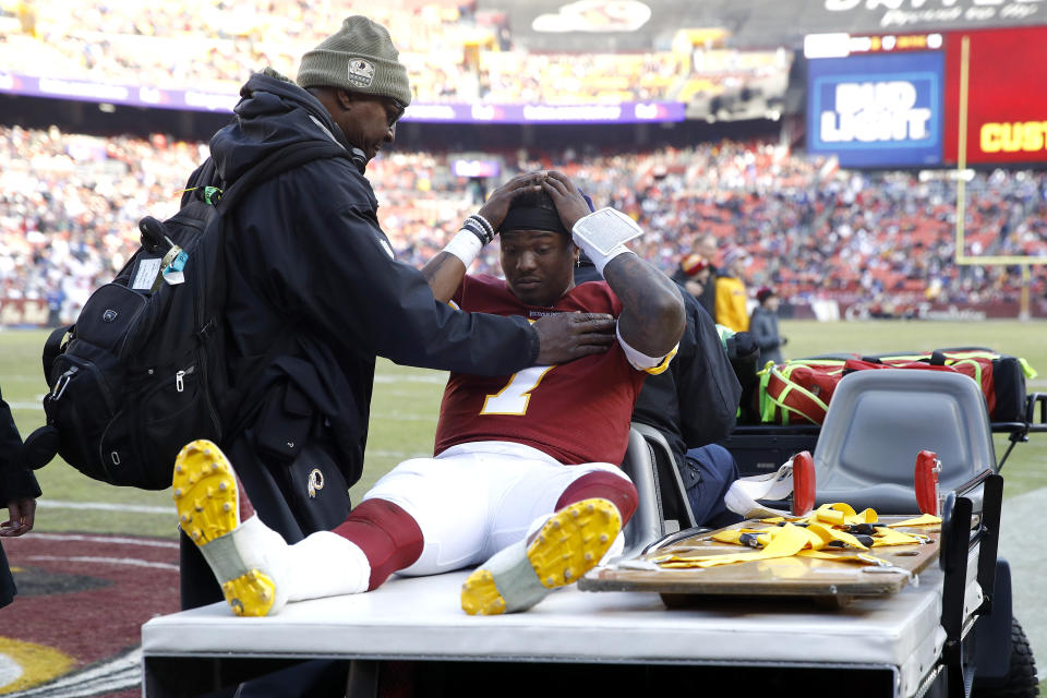 Washington Redskins quarterback Dwayne Haskins sits on cart while being taking off the field during the second half of an NFL football game against the New York Giants, Sunday, Dec. 22, 2019, in Landover, Md. (AP Photo/Patrick Semansky)