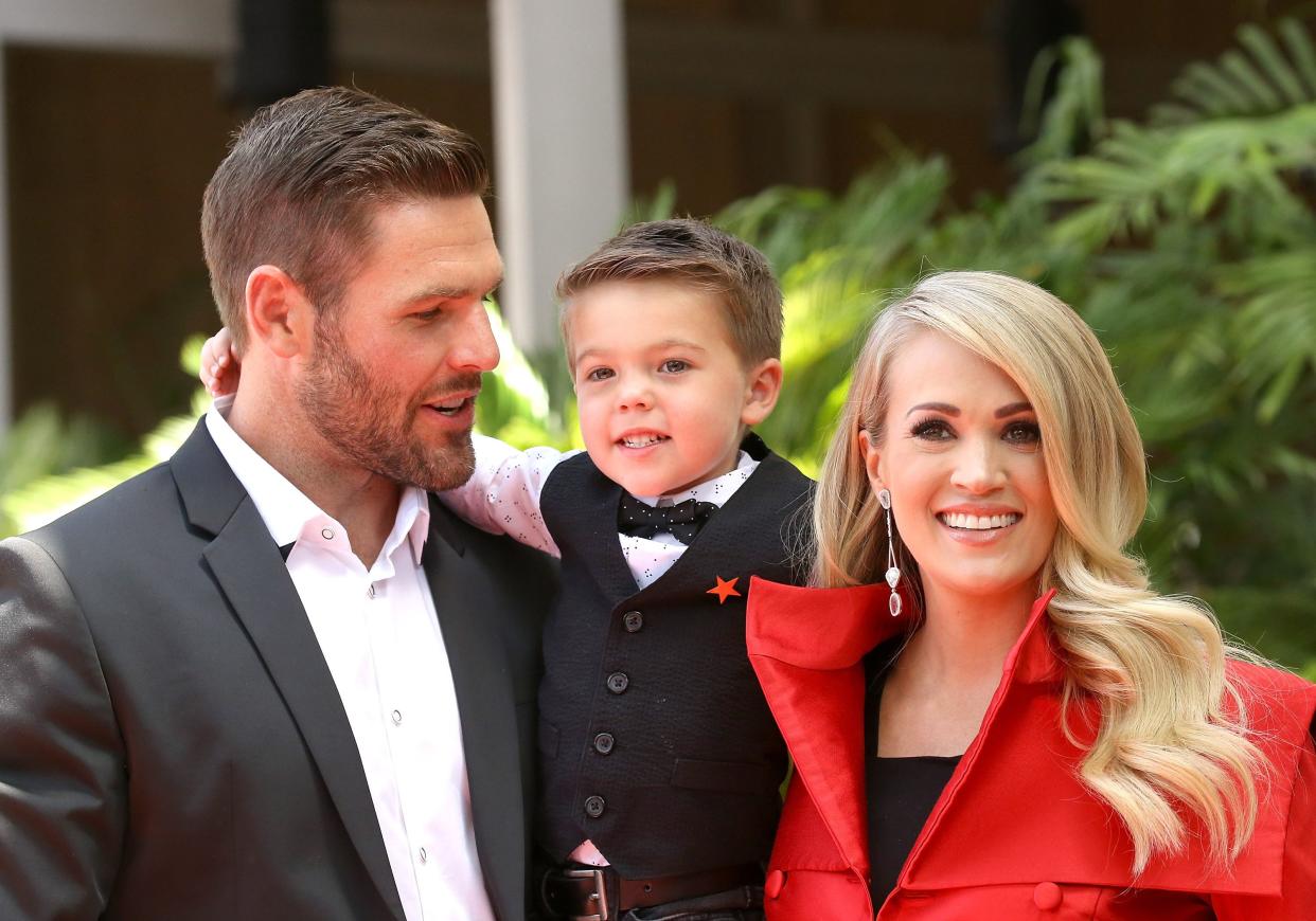 Carrie Underwood with her husband, Mike Fisher, and their son Isaiah attend the ceremony honoring Underwood with a star on the Hollywood Walk of Fame in 2018 in Hollywood. (Photo: Michael Tran/FilmMagic/Getty)