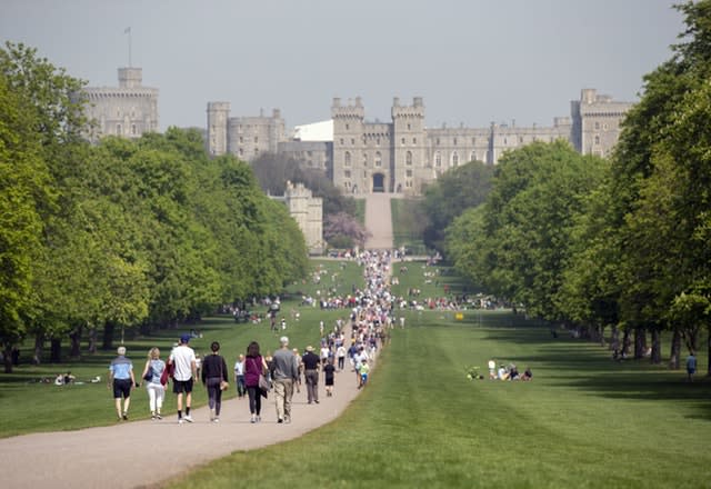 People enjoy the sunshine on the Long Walk in Windsor 