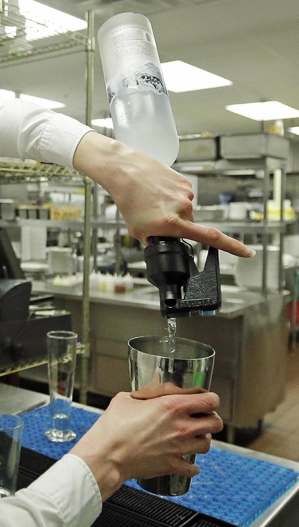 FILE - In this Feb. 26, 2013, file photo, manager Lindsay Pitts makes a mojito in the bar which is beyond the view of patrons, in the kitchen of La Jolla Groves Restaurant, in Salt Lake City. The Mormon church has issued a sweeping defense of Utah's famously strict liquor laws, drawing a line against tourism, restaurant and bar industry advocates who have helped ease alcohol regulations in recent years. Ahead of the upcoming legislative session, The Church of Jesus Christ of Latter-day Saints posted to its website a hefty multimedia policy statement urging lawmakers to uphold rules that church leaders say are "closely tied to the moral culture of the state." (AP Photo/Rick Bowmer, File)