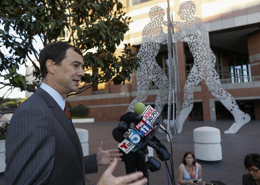 Shepard Koop, the attorney for Tom Calderon, takes question outside Los Angeles Federal court in Los Angeles Friday, Feb. 21, 2014. Calderon, a former lawmaker charged in a corruption probe along with his state senator brother, has pleaded not guilty in a Los Angeles court. (AP Photo/Damian Dovarganes)