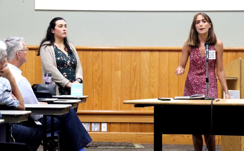 Hailey Hall (left), 25, speaks against the Florida Department of Environmental Protection's proposed harm rule for the state's freshwater springs at a Florida Department of Environmental Protection meeting at the Alachua County Headquarters Library on Monday, Aug. 28, 2023.
