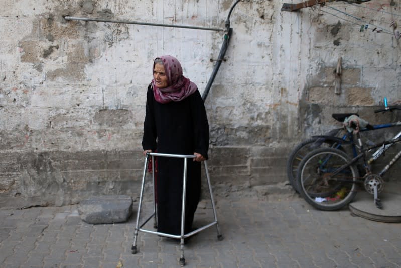 Palestinian woman stands outside home in the southern Gaza Strip