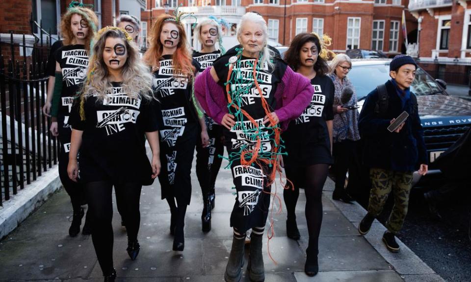 Sign of the times: Vivienne Westwood arrives with models at the #INEOSVTHEPEOPLE catwalk presentation outside Ineos headquarters in London in 2018.