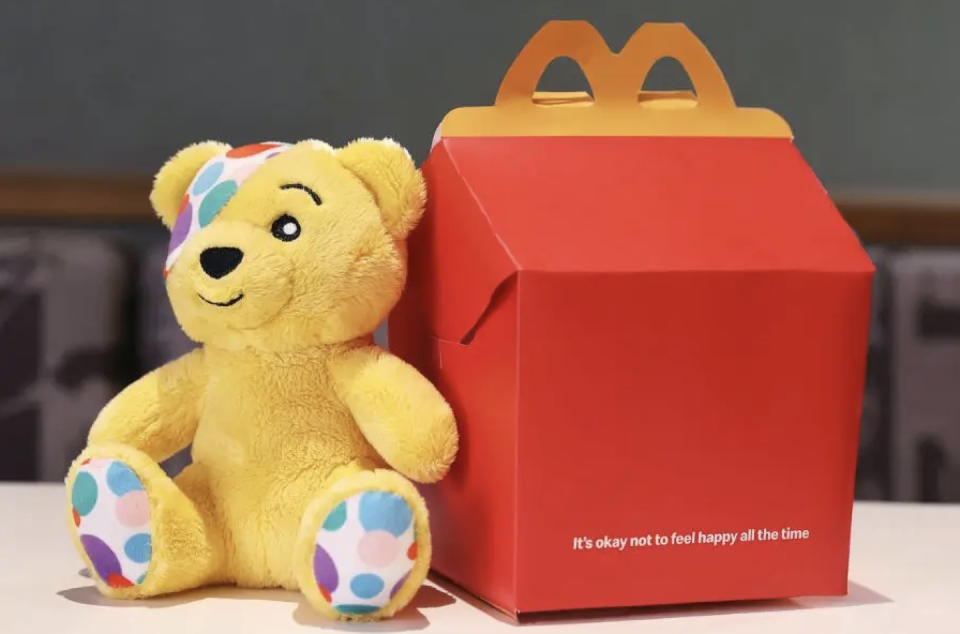 a stuffed bear next to a box