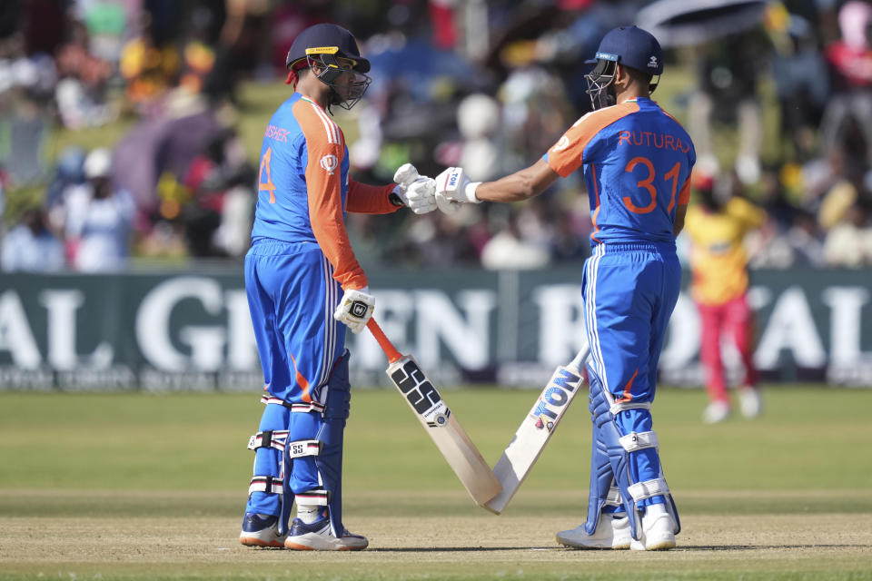 India's batsman Abishek Sharma, left, touches gloves with teammate Ruturaj Gaikwad during the T20 cricket between Zimbabwe and India at Harare Sports club,Sunday, July 7, 2024. (AP Photo/Tsvangirayi Mukwazhi)