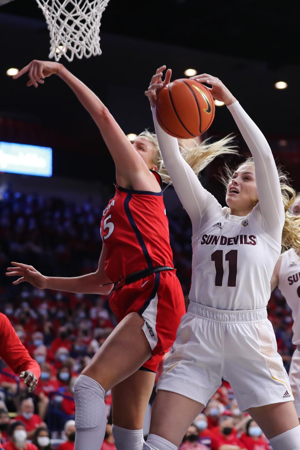 TUCSON, ARIZONA - FEBRUARY 13: Guard Sydney Erikstrup #11 of the Arizona State Sun Devils captures a rebound behind forward Cate Reese #25 of the Arizona Wildcats at McKale Center on February 13, 2022 in Tucson, Arizona. The Arizona Wildcats won 62-58. (Photo by Rebecca Noble/Getty Images)