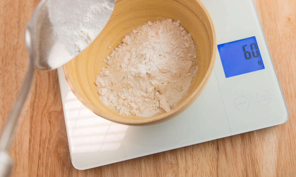 Weighing flour on a kitchen scale