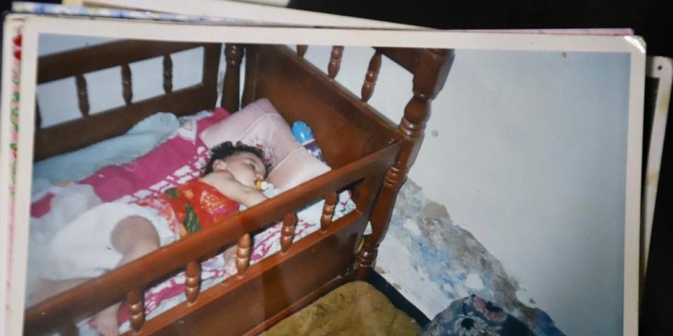 Khadidja as a baby, pictured in her cot.