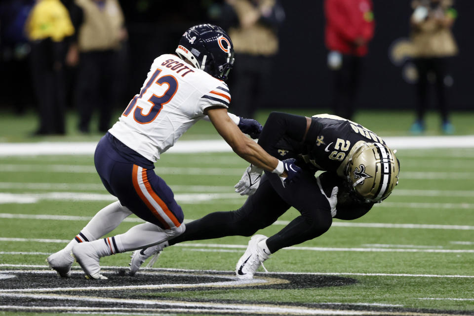 New Orleans Saints cornerback Paulson Adebo (29) intercepts a pass next to Chicago Bears wide receiver Tyler Scott (13) during the second half of an NFL football game in New Orleans, Sunday, Nov. 5, 2023. (AP Photo/Butch Dill)