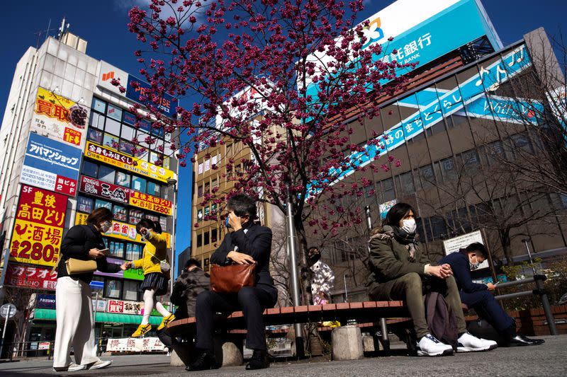 People wearing face masks, following an outbreak of the coronavirus, are seen in front of the Nakano station in Tokyo