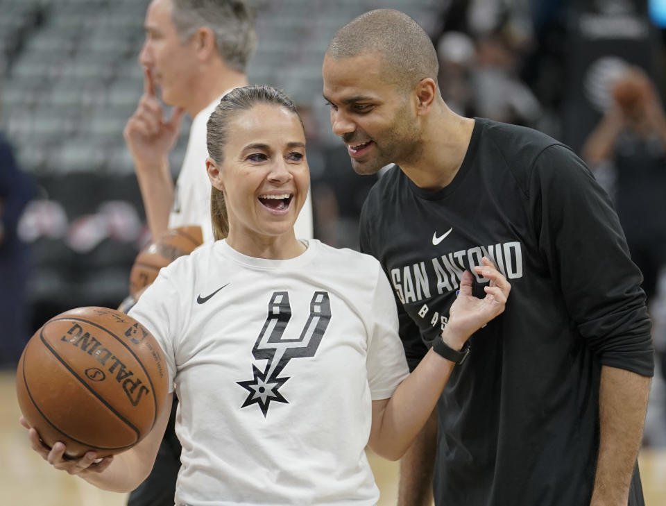 San Antonio Spurs guard Tony Parker, right, laughs with Spurs assistant coach Becky Hammon before an NBA basketball game against the Orlando Magic, Tuesday, March 13, 2018, in San Antonio. San Antonio won 108-72. (AP Photo/Darren Abate)