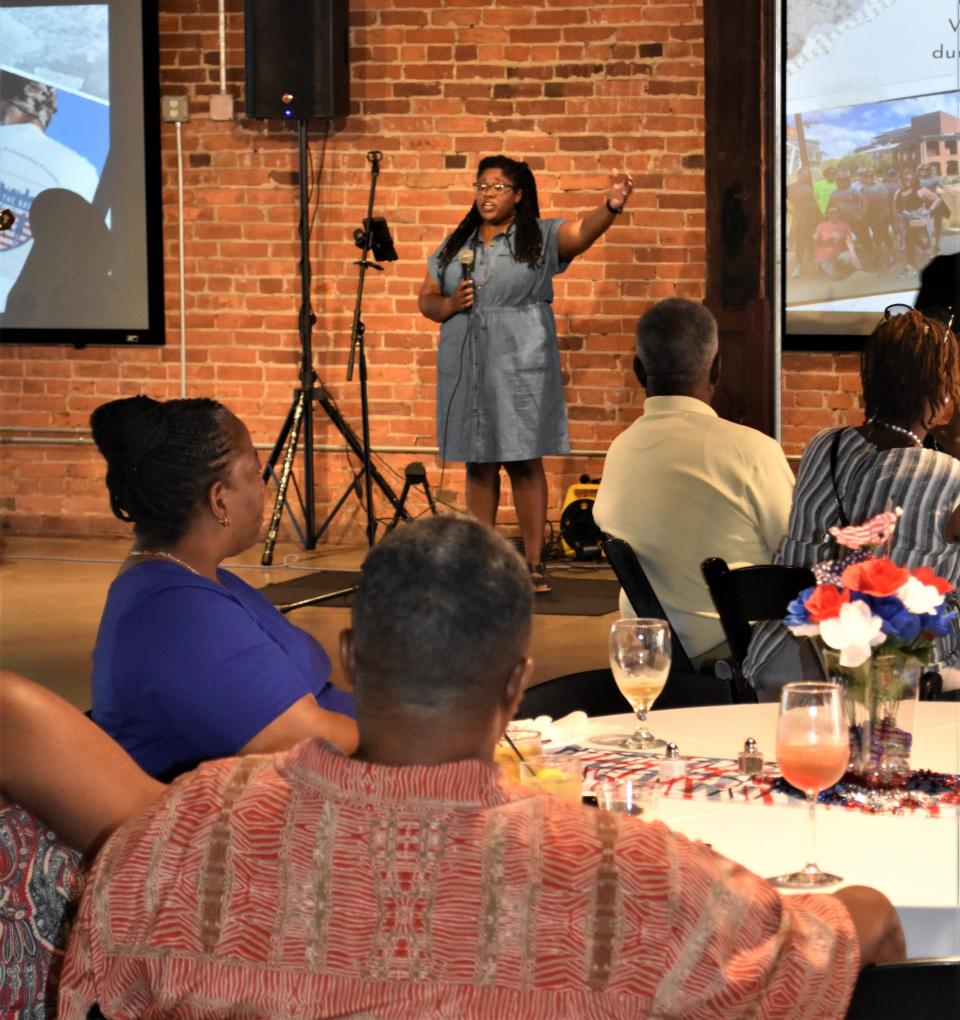 DeAndria Hardy talks to friends and supporters of the Battle Betty Foundation at the group's "Bourbon and Barbecue" event at Drayton Mills.