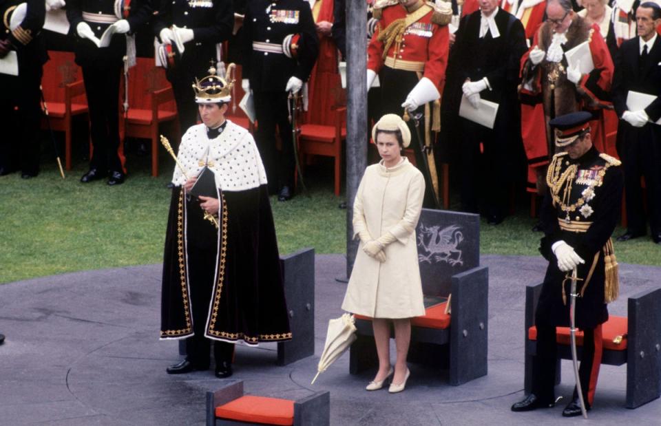 The Queen and the Duke of Edinburgh with Prince Charles, the Prince of Wales during his investiture at Caernarfon Castle (PA )