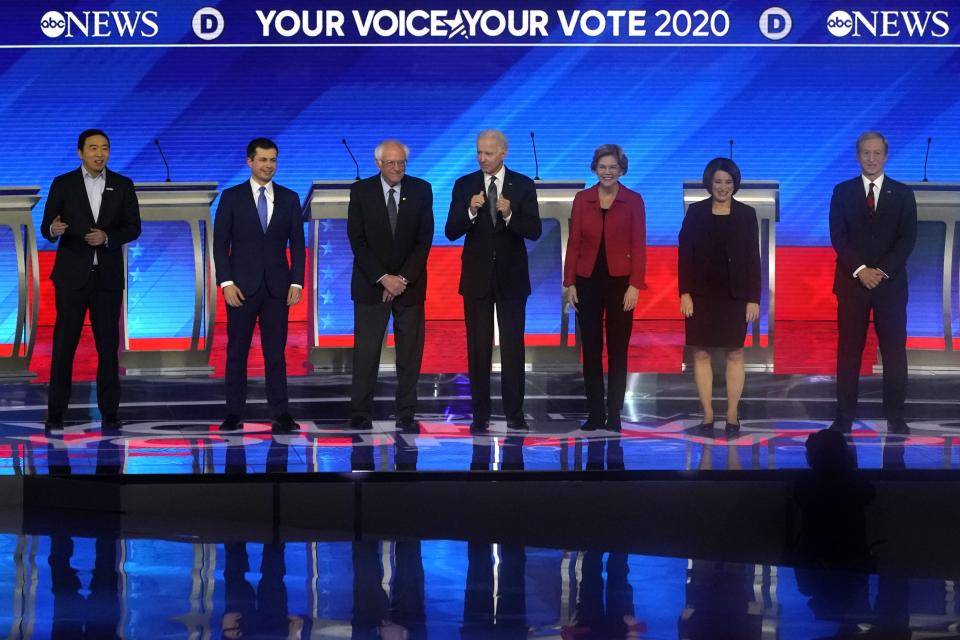 From left, Democratic presidential hopefuls entrepreneur Andrew Yang, former Mayor of South Bend, Indiana, Pete Buttigieg, Vermont Senator Bernie Sanders, former Vice President Joe Biden, Massachusetts Senator Elizabeth Warren, Minnesota Senator Amy Klobuchar and Billionaire activist Tom Steyer arrive onstage for the eighth Democratic primary debate of the 2020 presidential campaign season co-hosted by ABC News, WMUR-TV and Apple News at St. Anselm College in Manchester, New Hampshire, on February 7, 2020. 