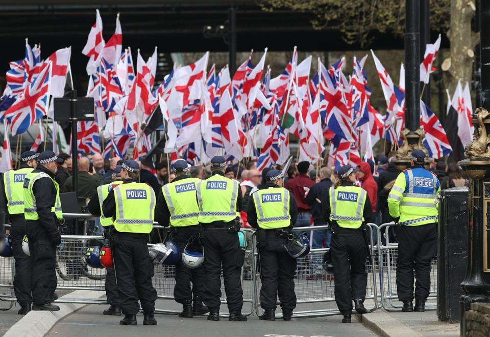 Police officers in front of Britain First and EDL protesters on Embankment in London, April 2017 (PA)