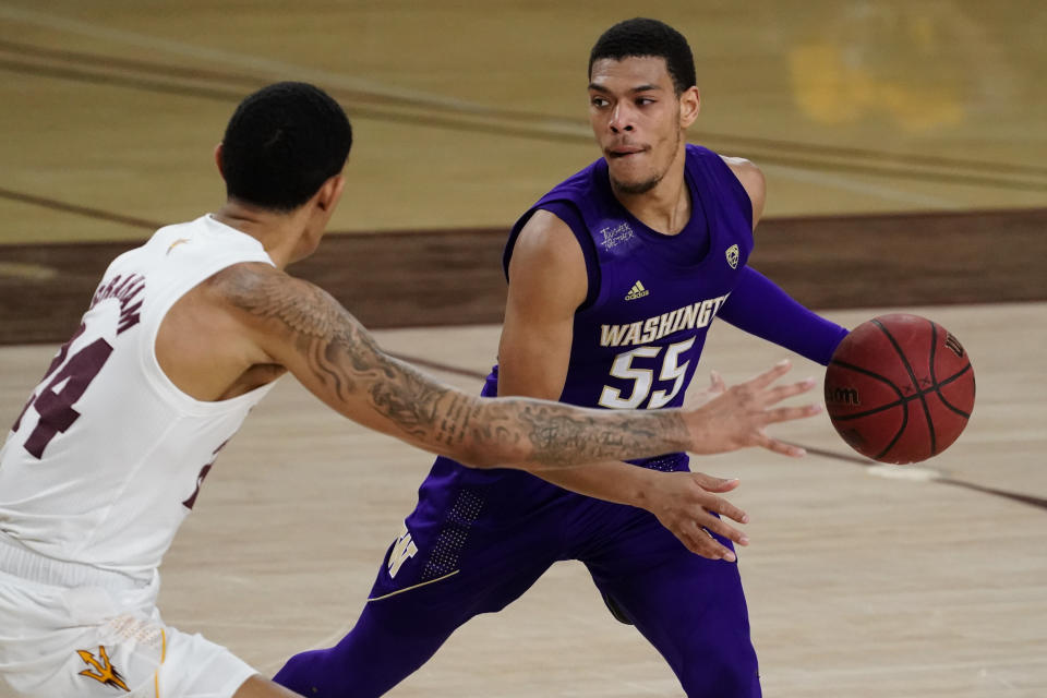 Washington guard Quade Green (55) carries the ball around Arizona State forward Jalen Graham (24) during the second half of an NCAA college basketball game, Thursday, Feb. 25, 2021, in Tempe, Ariz. (AP Photo/Rick Scuteri)