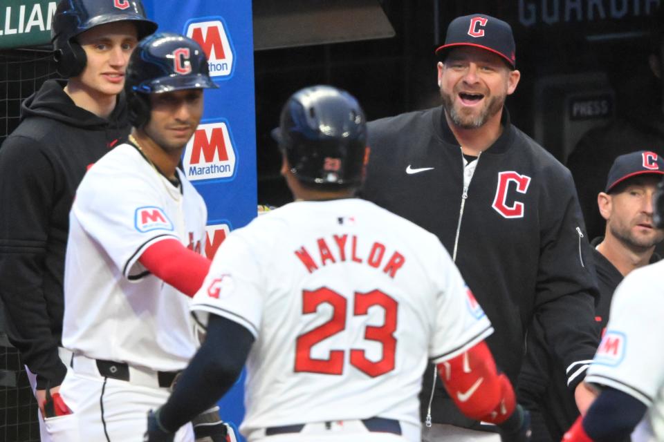 Guardians manager Stephen Vogt (right) reacts after a two-run home run by catcher Bo Naylor (23) against the Chicago White Sox on Wednesday in Cleveland.