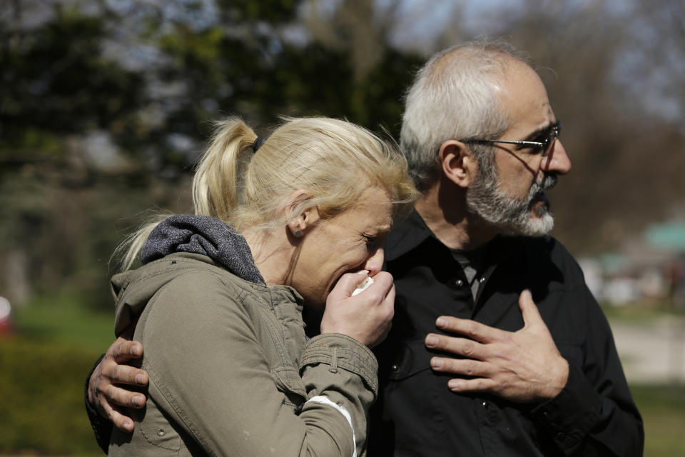 JoAnn Cunningham, mother of missing 5-year-old child Andrew "AJ" Freund, stands with her attorney George Killis outside of the Freund home as he speaks on her behalf and pleads with the public to help find AJ on Friday, April 19, 2019 in Crystal Lake, Ill. Crystal Lake police said Friday that they have no indication Andrew "AJ" Freund was abducted. They say canine units only picked up the boy's scent within the residence, which indicates Andrew didn't leave on foot. Police say Andrew's parents last saw him about 9 p.m. Wednesday and reported him missing Thursday when they woke up and couldn't find him in the home. (Stacey Wescott/Chicago Tribune via AP)