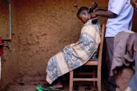 MPANDA, BURUNDI - JUNE 23: A boy gets his hair cut June 23, 2015 in Mpanda, Burundi. The head of Burundi's influential rights group, Aprodeh, says at least 70 people, mostly civilians, have been killed and hundreds of others wounded following weeks of political unrest in the small, impoverished country in the African Great Lakes region of East Africa. The violence started after President Pierre Nkurunziza announced his controversial bid for a third consecutive five-year term in office. The Office of the UN High Commissioner for Refugees (UNHCR) has said the violence in Burundi has forced more than 100,000 people to flee to neighboring countries. (Photo by Spencer Platt/Getty Images)