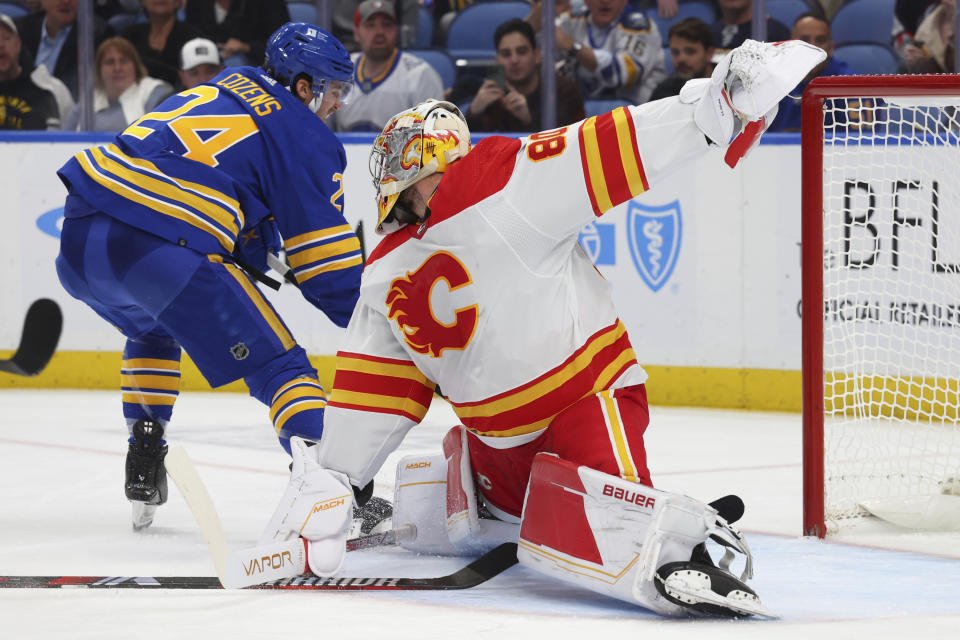 Buffalo Sabres center Dylan Cozens (24) is stopped by Calgary Flames goaltender Dan Vladar (80) during the first period of an NHL hockey game Thursday, Oct. 19, 2023, in Buffalo, N.Y. (AP Photo/Jeffrey T. Barnes)