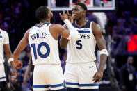 Minnesota Timberwolves guard Mike Conley (10) celebrates with guard Anthony Edwards (5) against the Phoenix Suns during the second half of Game 3 of an NBA basketball first-round playoff series, Friday, April 26, 2024, in Phoenix. (AP Photo/Matt York)