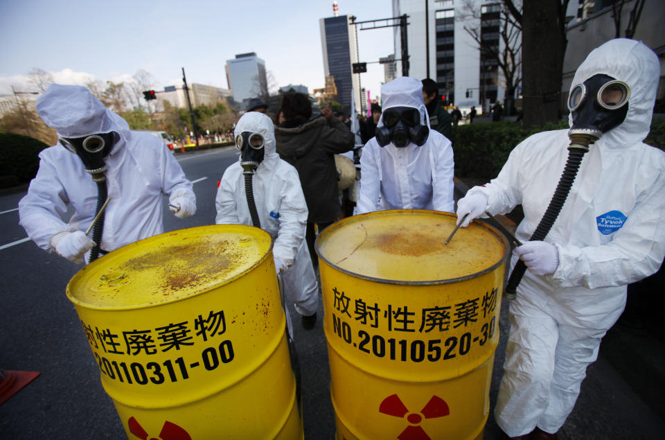 Costumed protesters beat drum cans during an anti-nuclear plant demonstration in Tokyo, Sunday, March 9, 2014. Banging on drums and waving "Sayonara nukes" signs, thousands of people rallied in a Tokyo park and marched to Parliament to demand an end to nuclear power ahead of the third anniversary of the Fukushima disaster. The demonstration Sunday is one of many such protests that have erupted since the March 11, 2011, nuclear disaster, the worst since Chernobyl. (AP Photo/Junji Kurokawa)