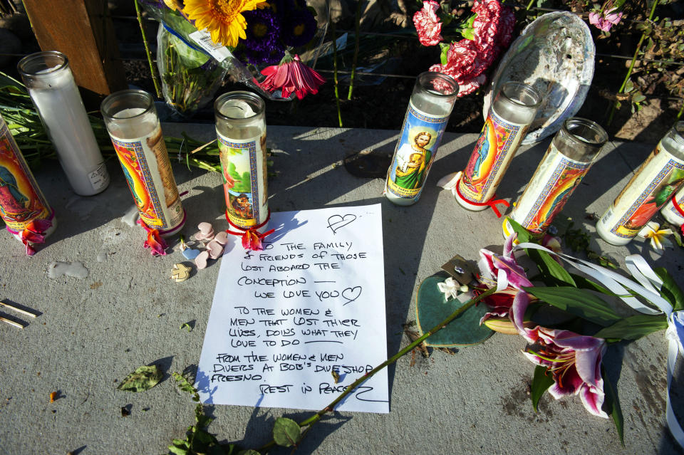 A handwritten message from members of the diving community is displayed at a memorial for the victims of Monday's dive boat fire at the Santa Barbara Harbor on Wednesday, Sept. 4, 2019, in Santa Barbara, Calif. (AP Photo/Christian Monterrosa )