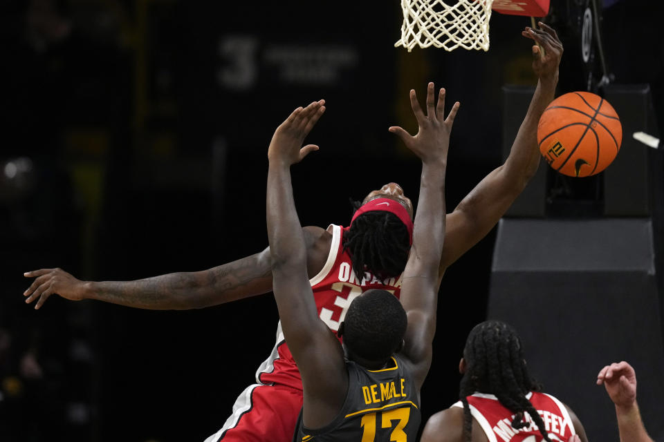 Ohio State center Felix Okpara (34) loses control of the ball as he shoots in front of Iowa forward Ladji Dembele during the second half of an NCAA college basketball game, Friday, Feb. 2, 2024, in Iowa City, Iowa. Iowa won 79-77. (AP Photo/Charlie Neibergall)