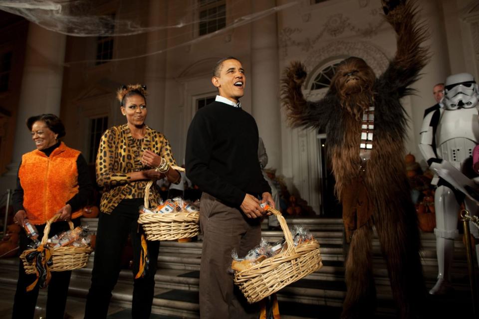 President Barack Obama, First Lady Michelle Obama and Marian Robinson welcome children from Washington, D.C., Maryland and Virginia schools for Halloween festivities at the North Portico of the White House, Oct. 31, 2009. (Official White House Photo by Pete Souza) This official White House photograph is being made available only for publication by news organizations and/or for personal use printing by the subject(s) of the photograph. The photograph may not be manipulated in any way and may not be used in commercial or political materials, advertisements, emails, products, promotions that in any way suggests approval or endorsement of the President, the First Family, or the White House.