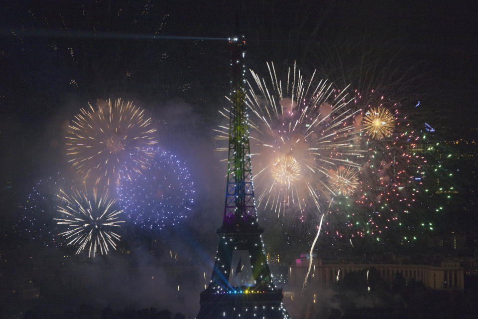 Fireworks illuminate the Eiffel Tower in Paris during Bastille Day celebrations late Sunday, July 14, 2013. (AP Photo/Thibault Camus)