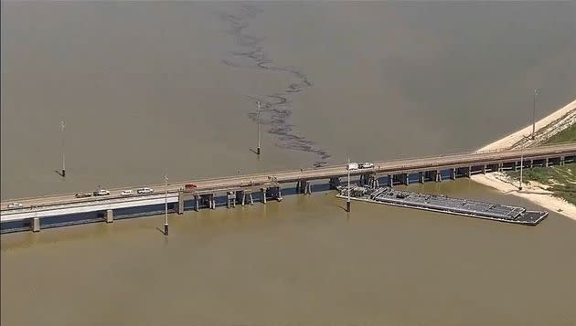 Oil spills into the surrounding waters after a barge hit a bridge in Galveston, Texas.