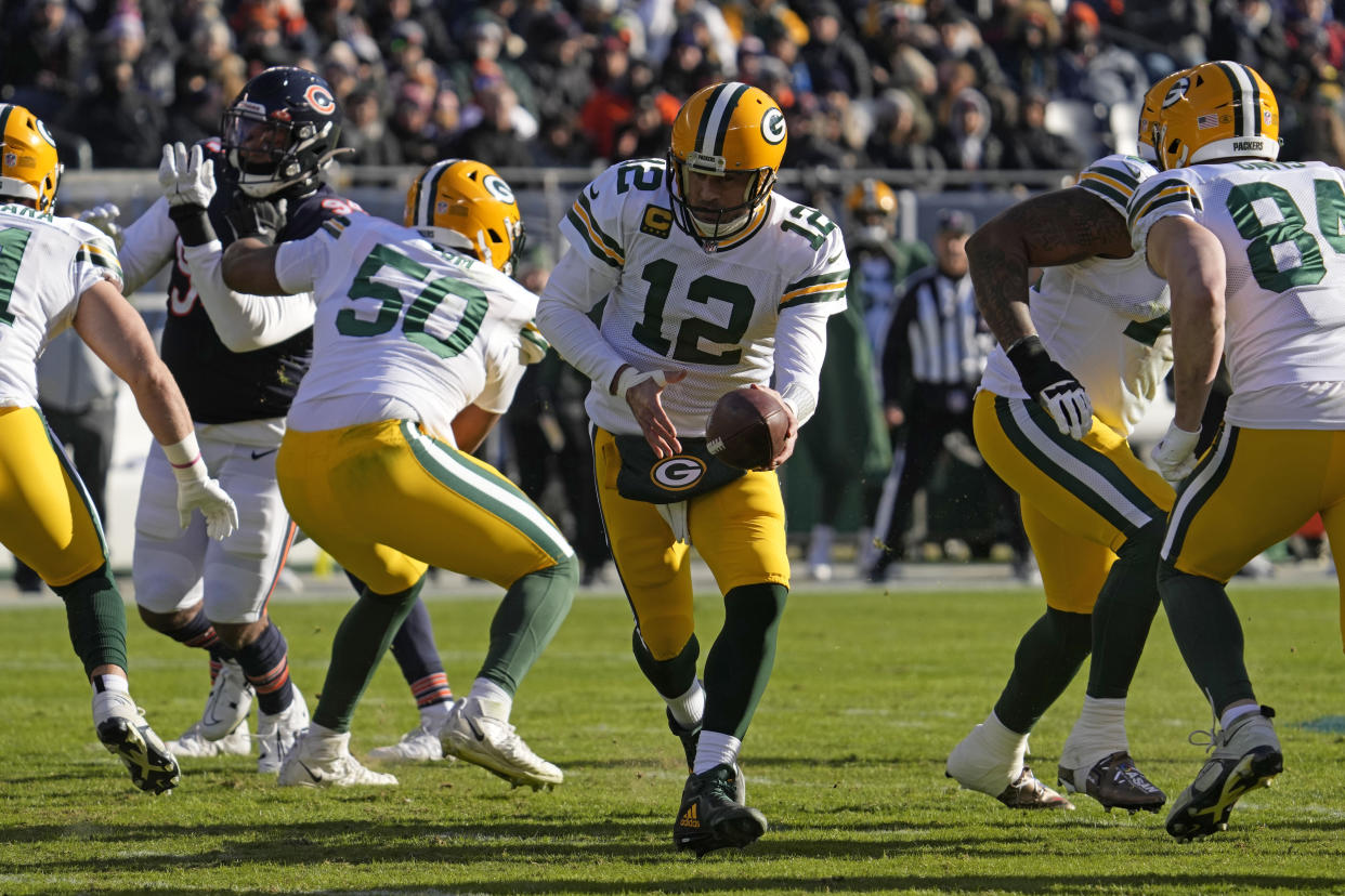 Green Bay Packers quarterback Aaron Rodgers (12) looks to drop off the ball during the first half of an NFL football game against the Chicago Bears, Sunday, Dec. 4, 2022, in Chicago. (AP Photo/Nam Y. Huh)