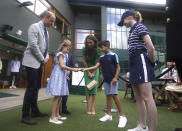 The Prince and Princess of Wales with Prince George and Princess Charlotte speak to Mu'awwiz who will perform the men's singles final coin toss on day fourteen of the 2023 Wimbledon Championships at the All England Lawn Tennis and Croquet Club in Wimbledon, Sunday July 16, 2023. (Victoria Jones/Pool photo via AP)