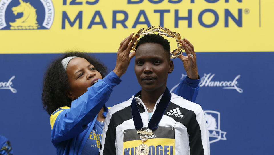 Acting Boston Mayor Kim Janey places a wreath on womens winner Diana Kipyokei, of Kenya at the 125th Boston Marathon in Boston, Massachusetts, on Oct. 11, 2021. / Credit: Jessica Rinaldi/The Boston Globe via Getty Images