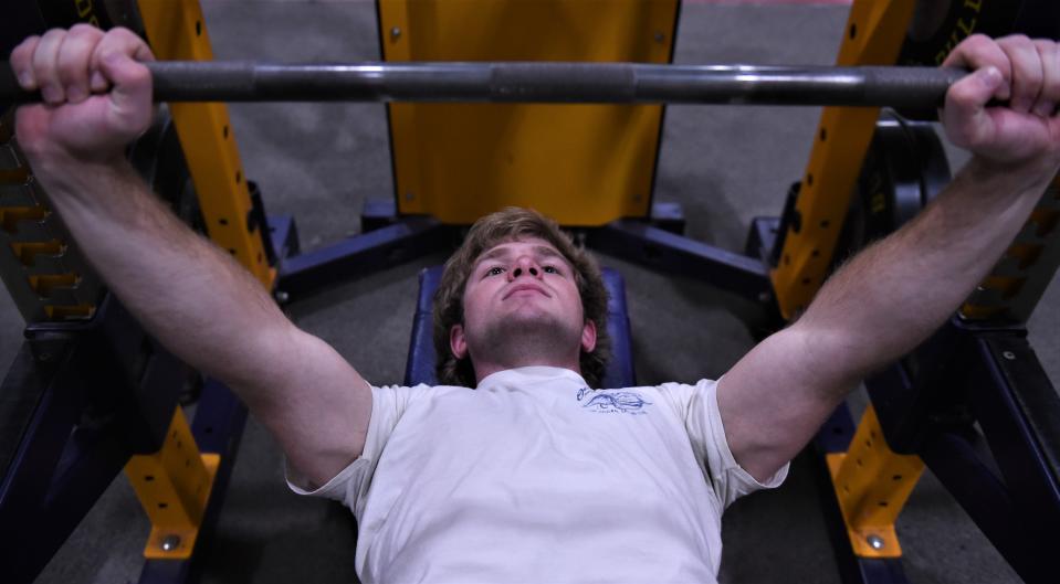 Wylie's Landry Carlton lifts in the bench press during practice Wednesday at Wylie High School's Doghouse.