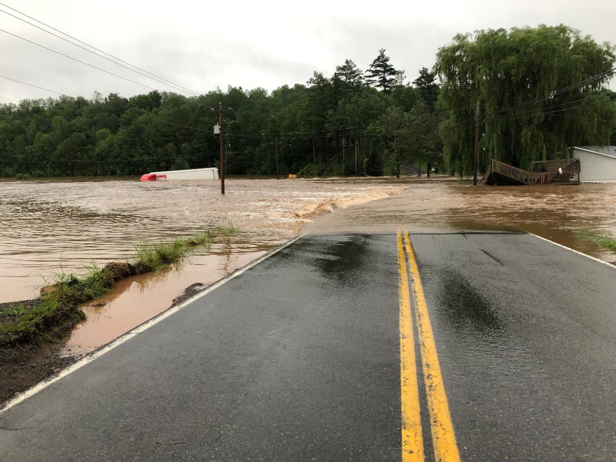 A transport truck is seen partially submerged during flooding in Windsor, N.S.  (Peter Dawson/CBC - image credit)