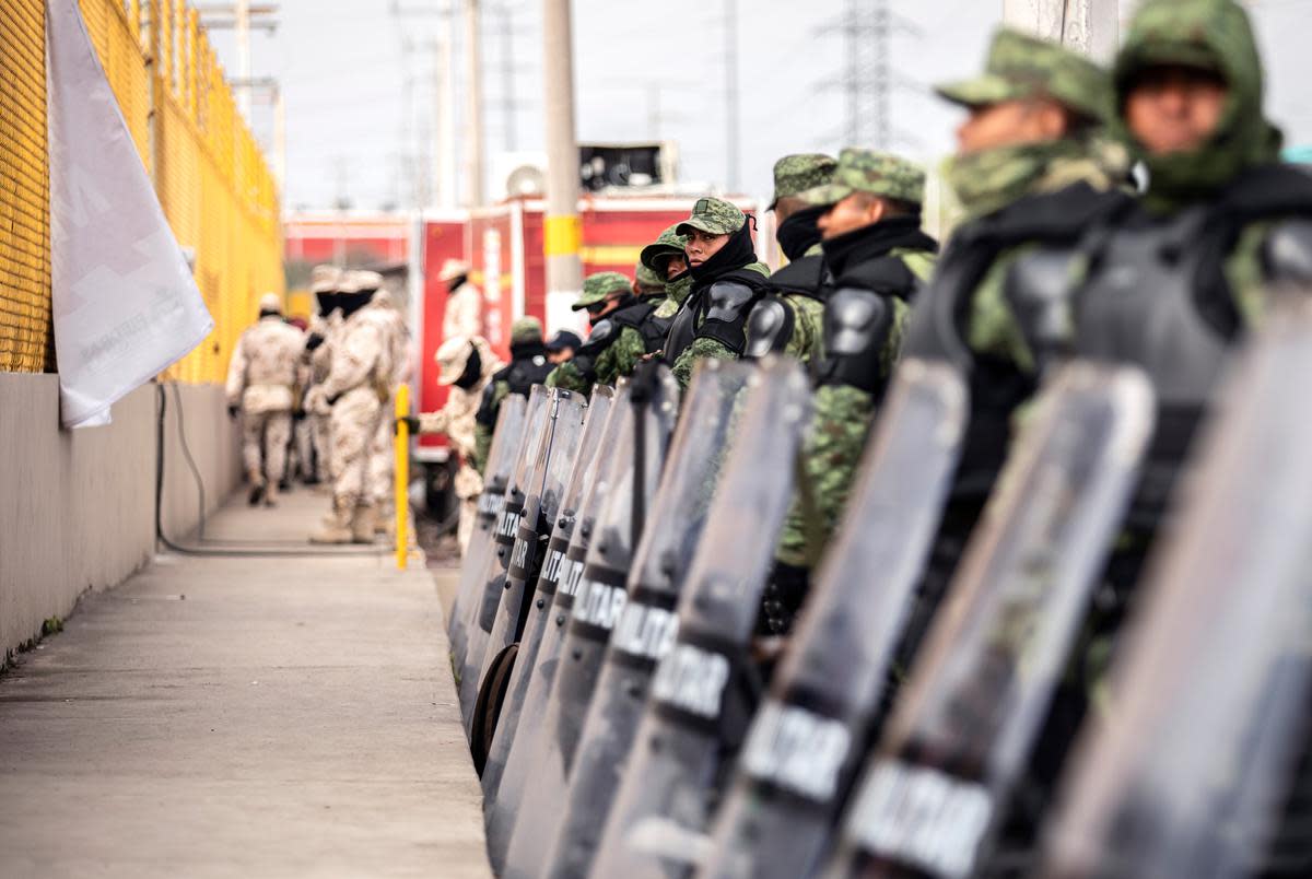 The Mexican military guards the perimieter of the shelter where an estimated 1700 migrants are currently being held in Piedras Negras. Feb. 12, 2019. 