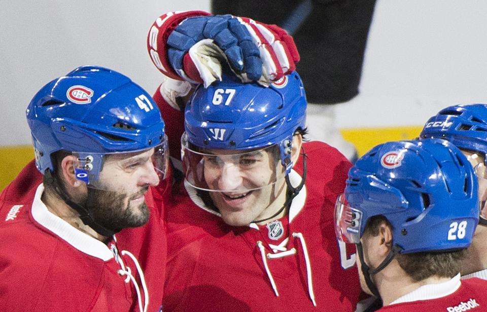 Montreal Canadiens' Max Pacioretty (67) celebrates with teammates Alexander Radulov (47) and Nathan Beaulieu after scoring against the Colorado Avalanche during the second period of an NHL hockey game in Montreal, Saturday, Dec. 10, 2016. (Graham Hughes/The Canadian Press via AP)