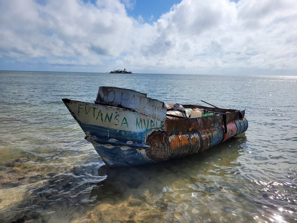 A homemade migrant boat sits on the sand and shallow water of Sombrero Beach in the Middle Florida Keys city of Marathon on Thursday, Dec. 1, 2022. The Border Patrol said 25 people came to shore on the vessel.