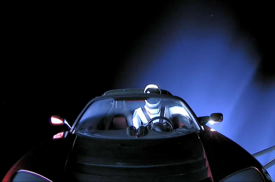 A Hot Wheels Tesla Roadster, complete with a tiny Starman, sits on the dashboard of Elon Musk’s Roadster after being launched into deep space. <cite>SpaceX</cite>