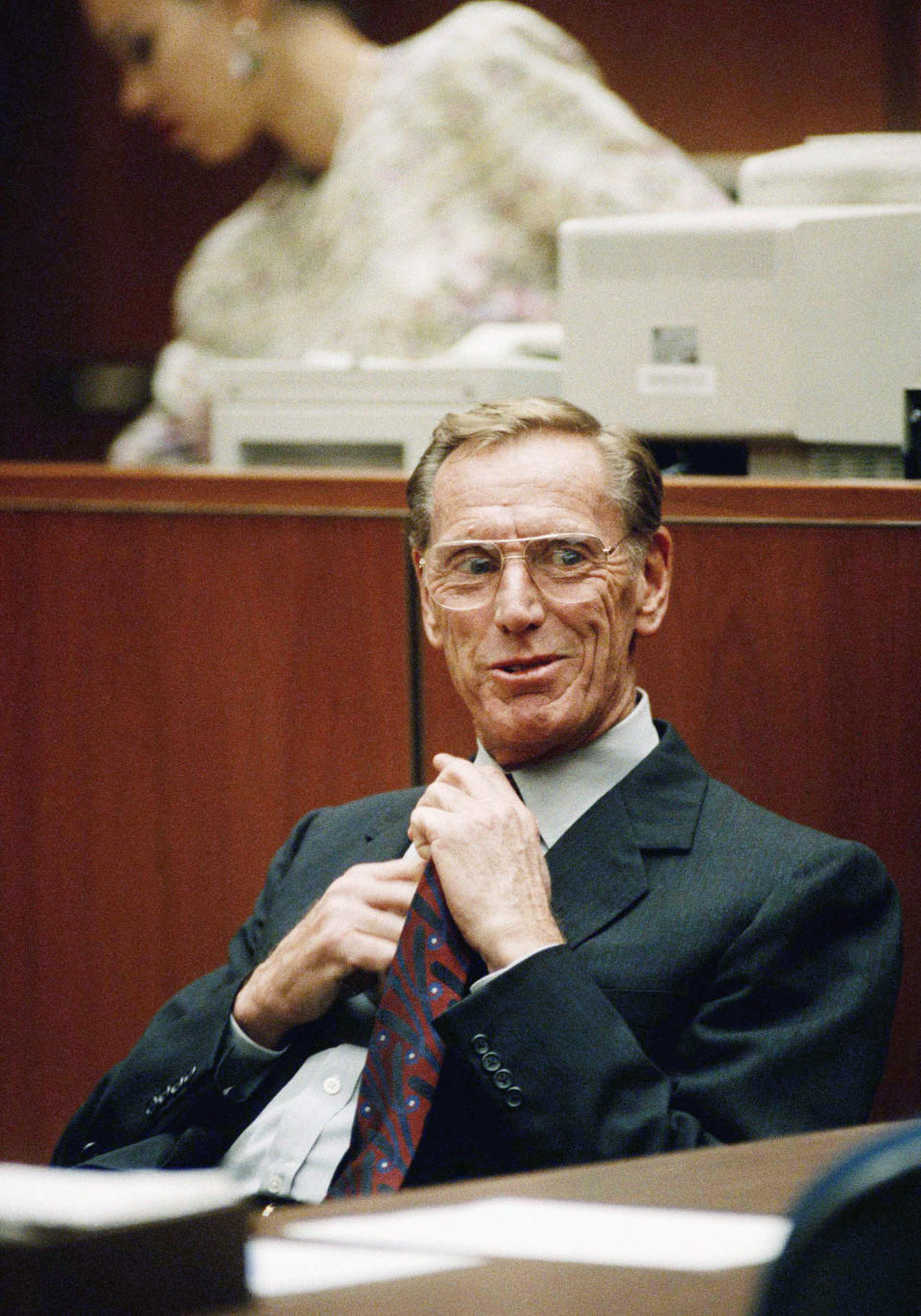 FILE - In this Thursday, Nov. 14, 1991, file photo, Charles Keating Jr., adjusts his tie as he sits in a Los Angeles courtroom. Keating, the financier who was disgraced for his role in the costliest savings and loan failure of the 1980s, has died. He was 90. A person with direct knowledge of the death confirmed that Keating died but didn't provide further details. The person wasn't authorized to release the information and spoke on condition of anonymity. (AP Photo/Nick Ut)