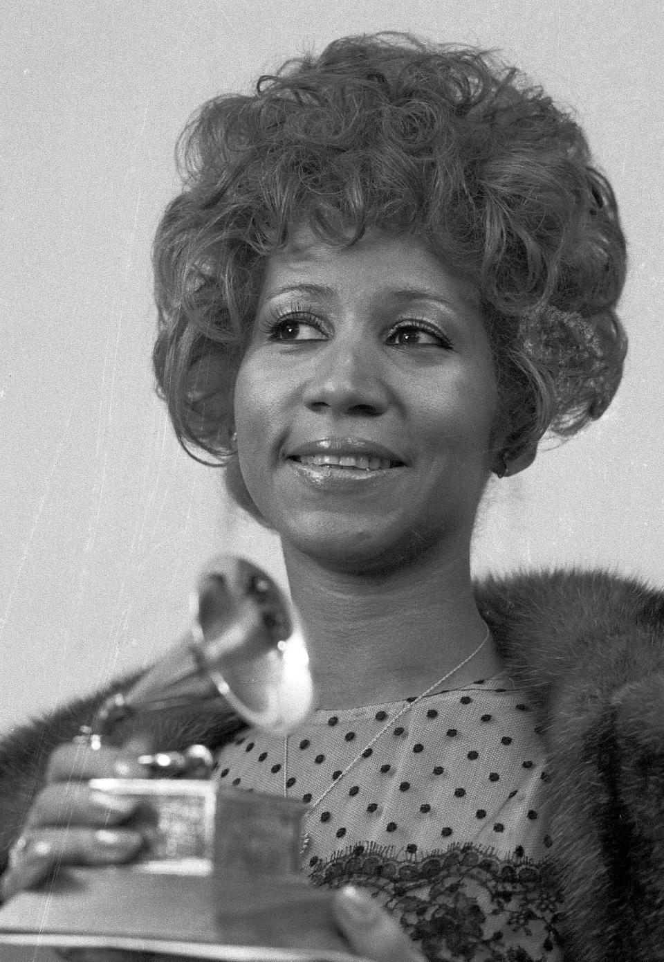 FILE - In this March 13, 1972 file photo, Aretha Franklin holds her Grammy Award for Best Rhythm and Blue performance of the song "Bridge Over Troubled Waters," in New York. Franklin died Thursday, Aug. 16, 2018 at her home in Detroit. She was 76. (AP Photo/Dave Pickoff, File)