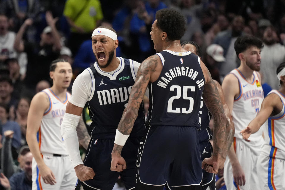 Dallas Mavericks center Daniel Gafford, left, and forward P.J. Washington (25) celebrate a basket by Gafford in the second half of an NBA basketball game against the Oklahoma City Thunder in Dallas, Saturday, Feb. 10, 2024. (AP Photo/Tony Gutierrez)