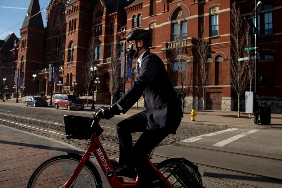 Cincinnati Mayor Aftab Pureval rides a Red Bike to his swearing-in ceremony at Washington Park in Over-the-Rhine on Jan. 4, 2022.