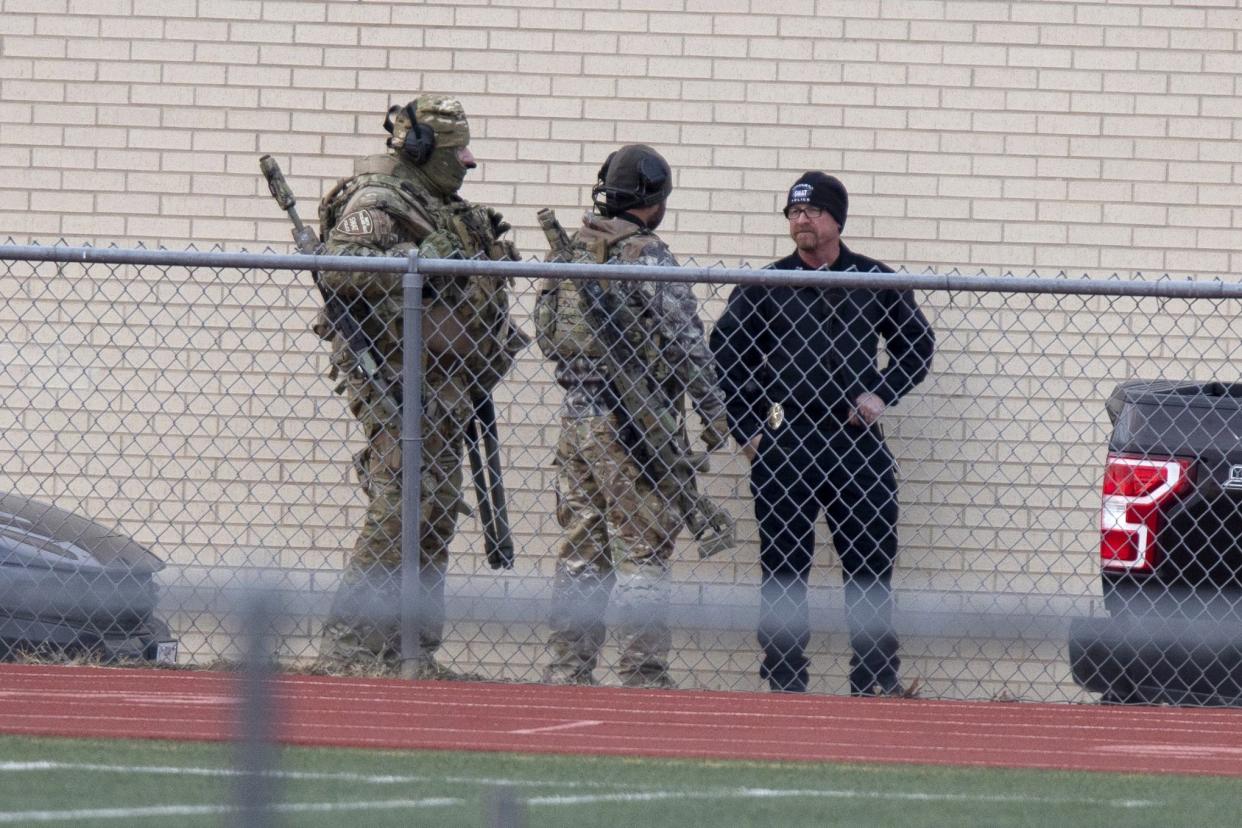 Law enforcement officials gather at a local school near the Congregation Beth Israel synagogue on Saturday, Jan. 15, 2022, in Colleyville, Texas.