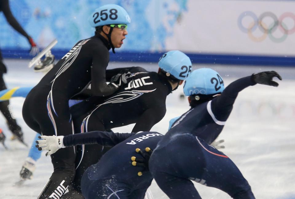 U.S. skaters and South Korea's skaters crash during the men's 5,000 metres short track speed skating relay semi-final event at the Iceberg Skating Palace during the 2014 Sochi Winter Olympics February 13, 2014. REUTERS/Alexander Demianchuk (RUSSIA - Tags: SPORT SPEED SKATING OLYMPICS)